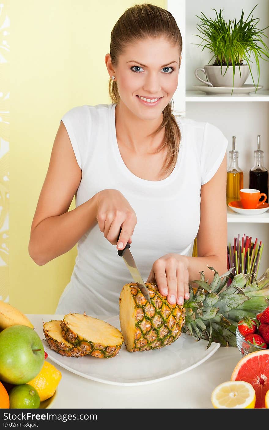 Beauty, young girl slicing pineapple