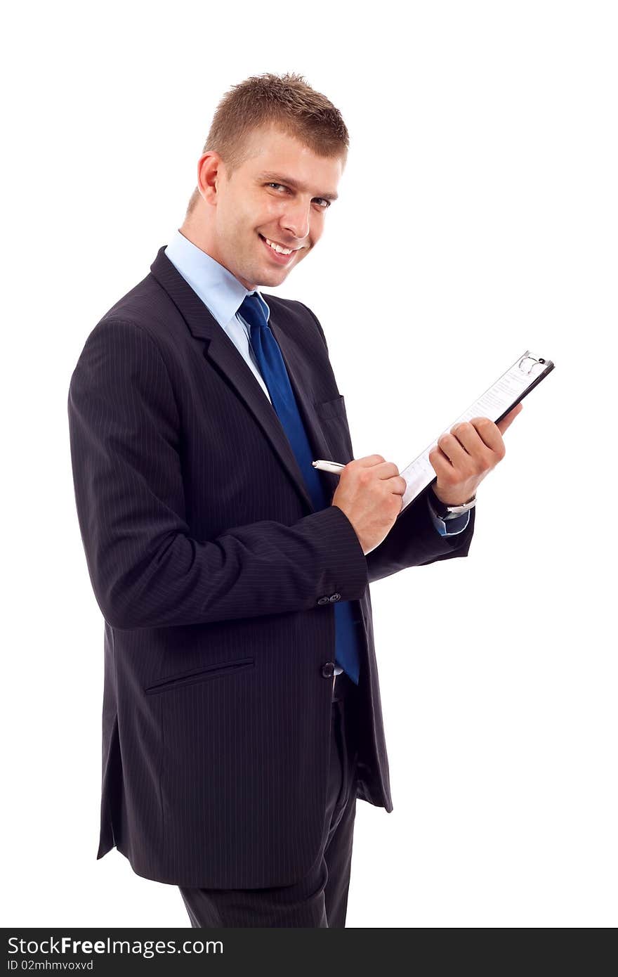 Handsome Businessman in black outfit shot in studio isolated on white - writing on clipboard. Handsome Businessman in black outfit shot in studio isolated on white - writing on clipboard