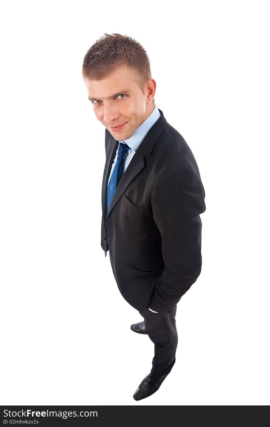 Wide angle picture of a business man standing with hands in pockets over white. Wide angle picture of a business man standing with hands in pockets over white