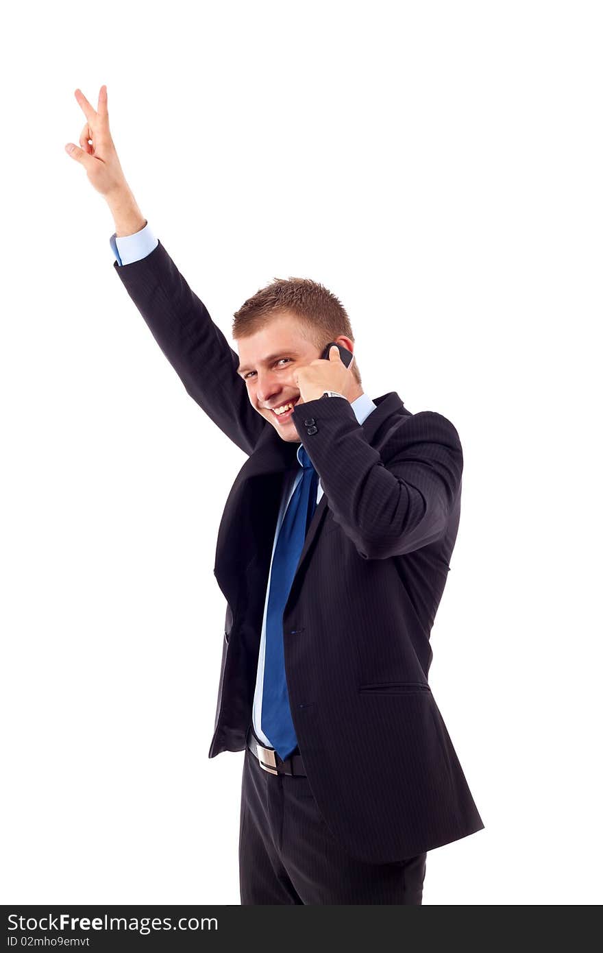 A smiling young business man discussing on a cell phone, isolated on white background. A smiling young business man discussing on a cell phone, isolated on white background