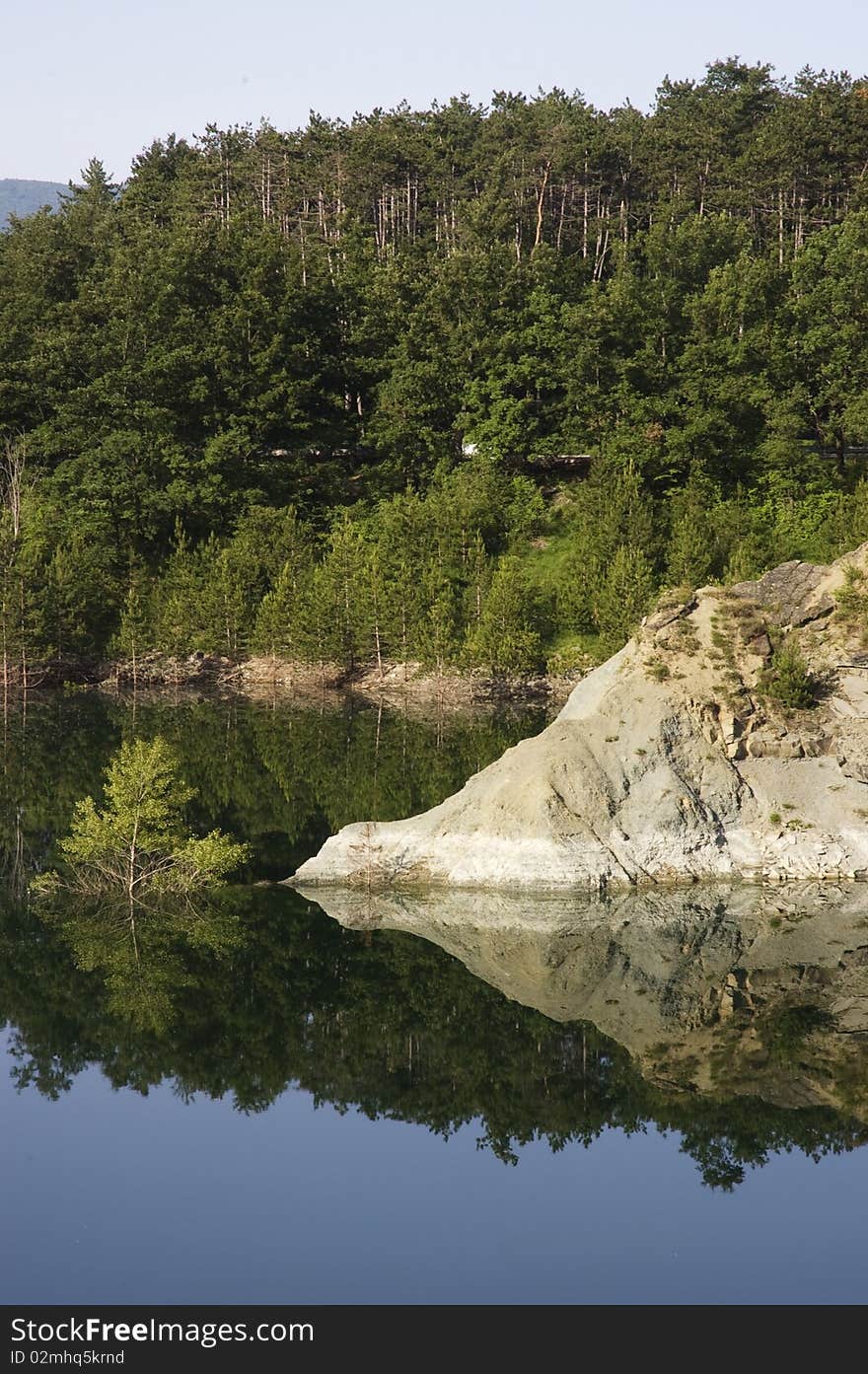 After much rain, the  level in the river rises and the tops of trees emerge from the water. After much rain, the  level in the river rises and the tops of trees emerge from the water.