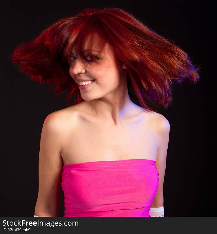 Young fresh female model with red hair in  a studio setting. Cute smile. Young fresh female model with red hair in  a studio setting. Cute smile.