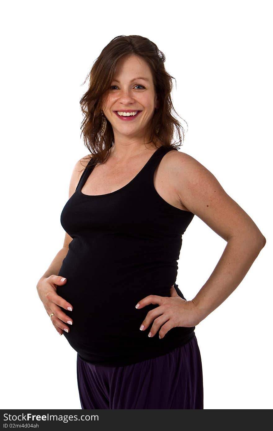 Young pregnant woman in a studio setting isolated over white. Young pregnant woman in a studio setting isolated over white.