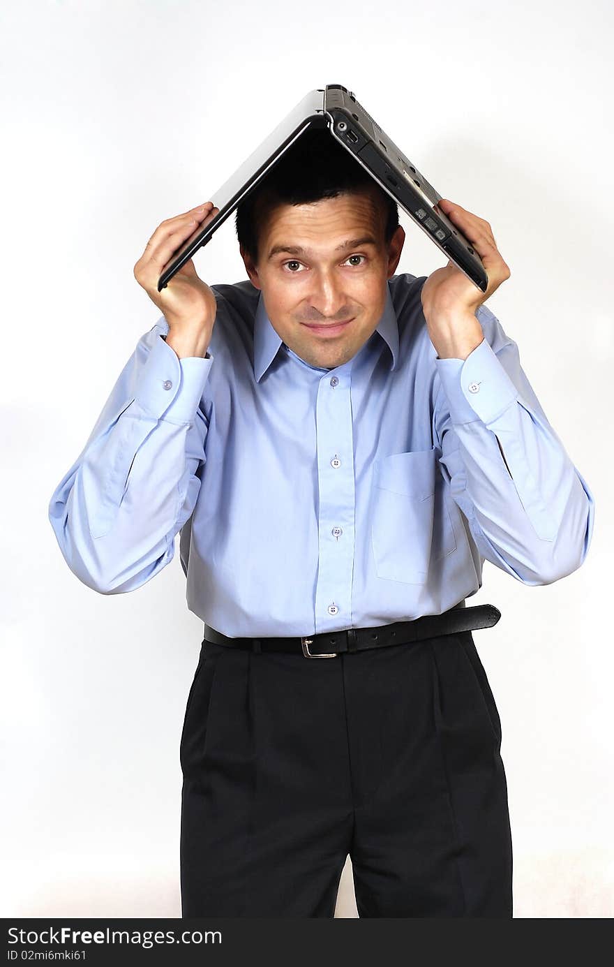 Smiling man with the laptop computer above the head on the white background