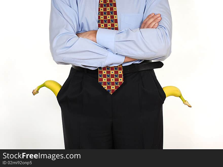 Man in the suit with the banana into pockets on the white background. Man in the suit with the banana into pockets on the white background