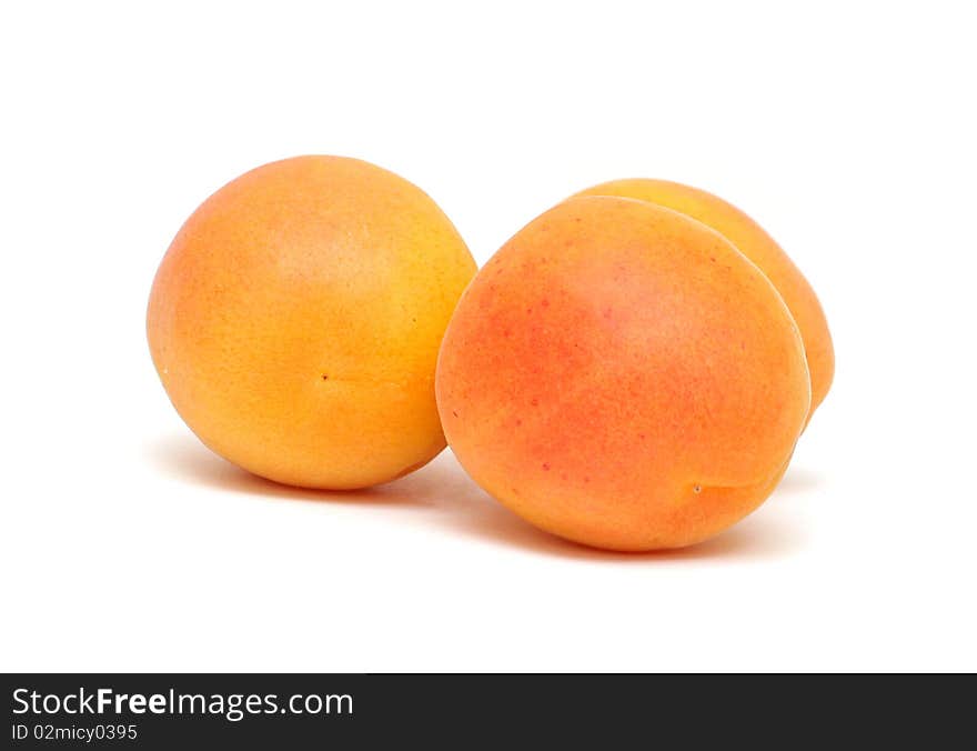 Three apricot isolated on white background