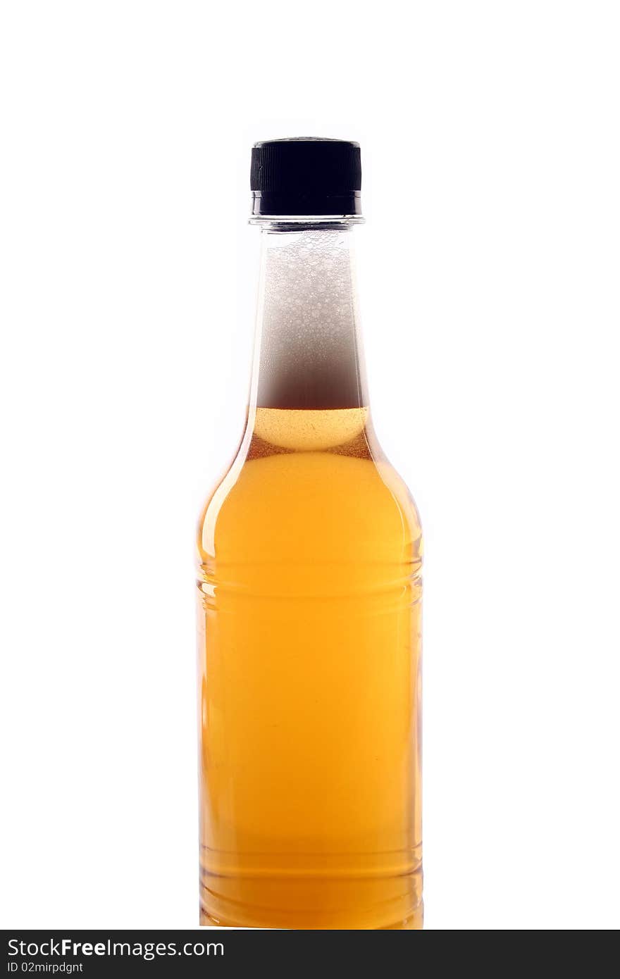 A bottle of beer is slanted with white background