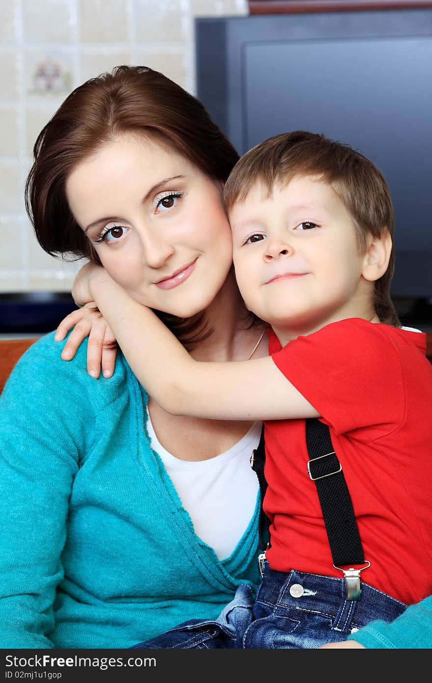 Happy pregnant woman with her son at home. Happy pregnant woman with her son at home.