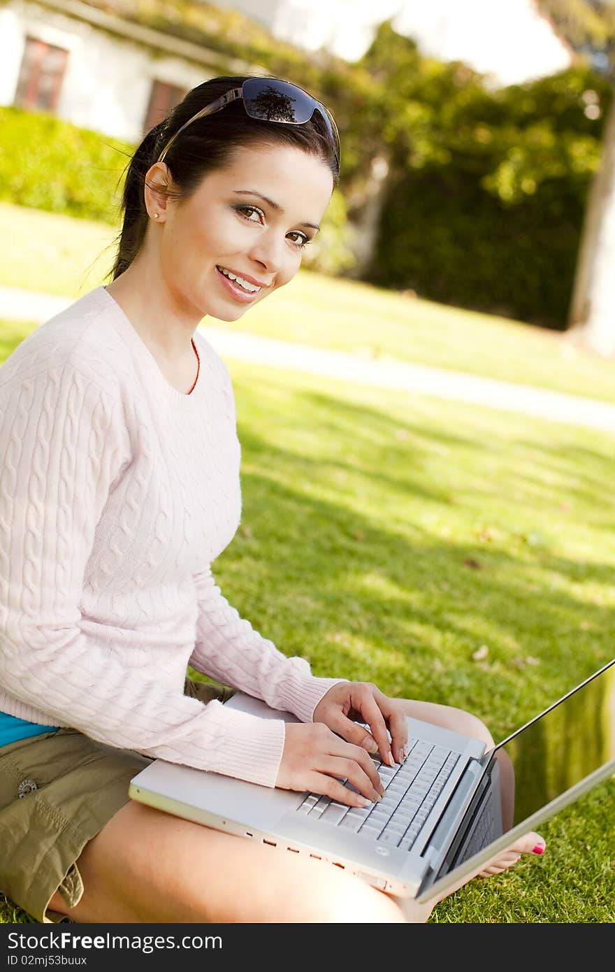 Young student using computer outside. Young student using computer outside