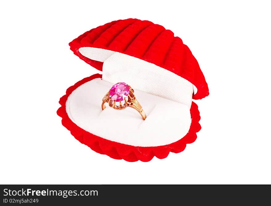 A red seashell box with golden ring