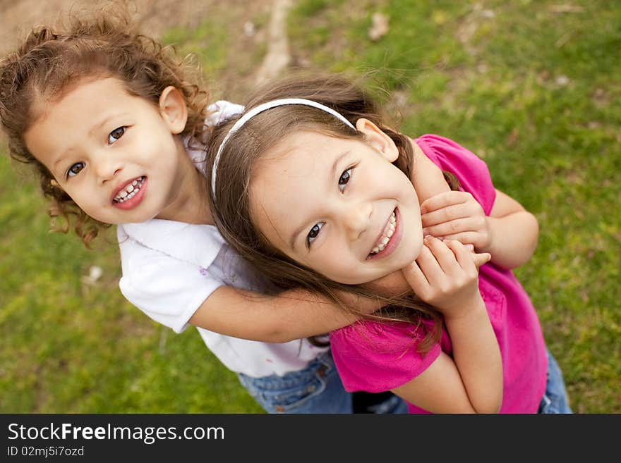 Cute little sisters playing outside