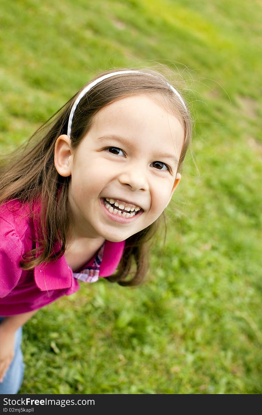 Portrait of a cute little girl outside