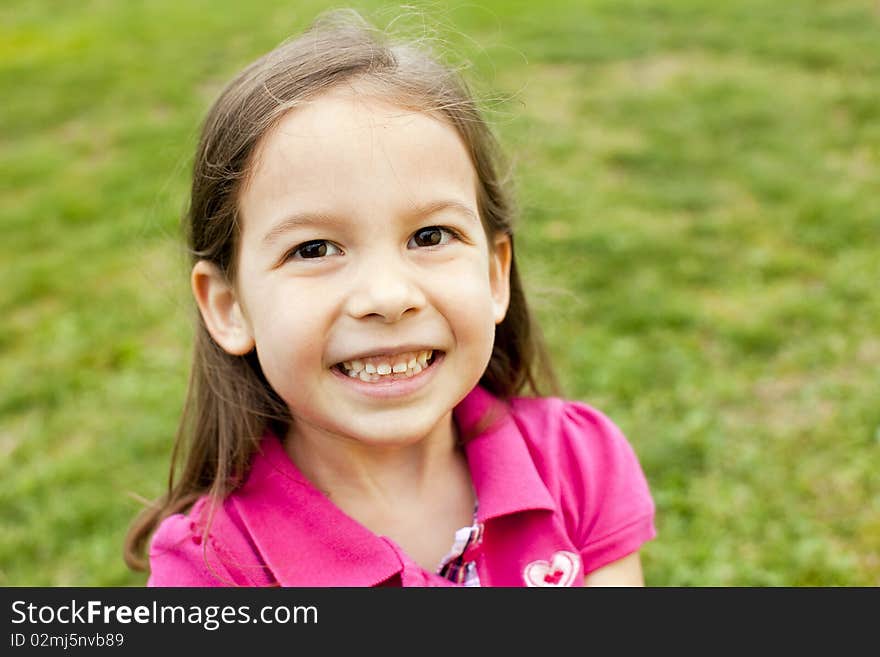 Portrait of a cute little girl outside