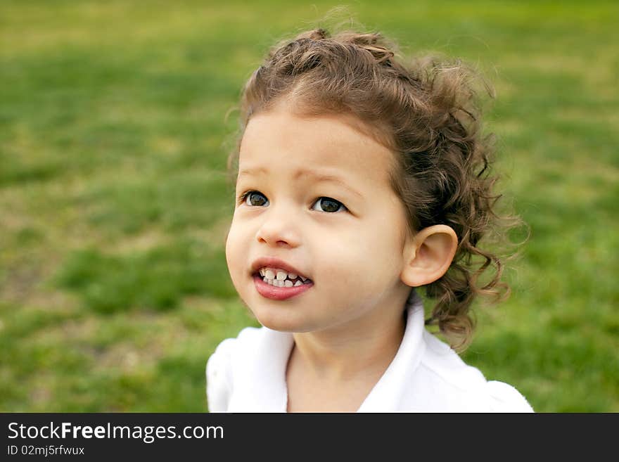 Portrait of a cute little girl outside