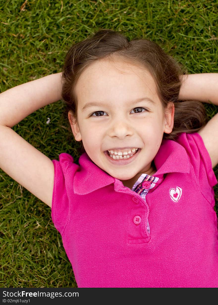 Cute little girl outside in the grass