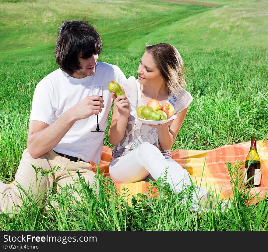 Beautiful girl with fruits and boy with wineglass