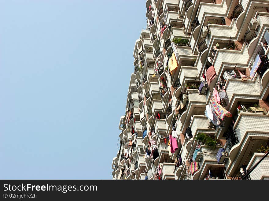 Chinese flats to one side with blue sky