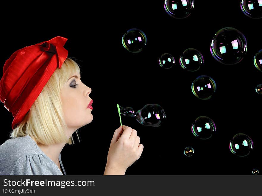 Cute blond girl plays with bubbles in studio. Cute blond girl plays with bubbles in studio