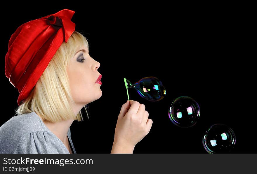 Cute blond girl plays with bubbles in studio. Cute blond girl plays with bubbles in studio