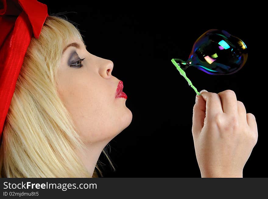 Cute blond girl plays with bubbles in studio. Cute blond girl plays with bubbles in studio