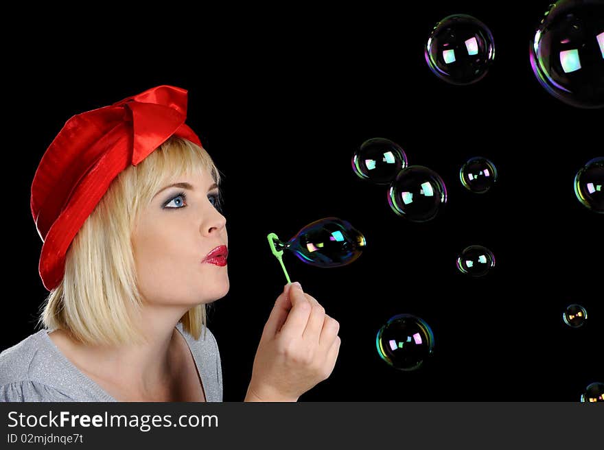 Cute blond girl plays with bubbles in studio. Cute blond girl plays with bubbles in studio