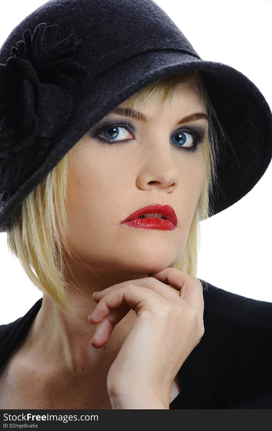 Beautiful woman poses for a portrait in her vintage hat. Beautiful woman poses for a portrait in her vintage hat