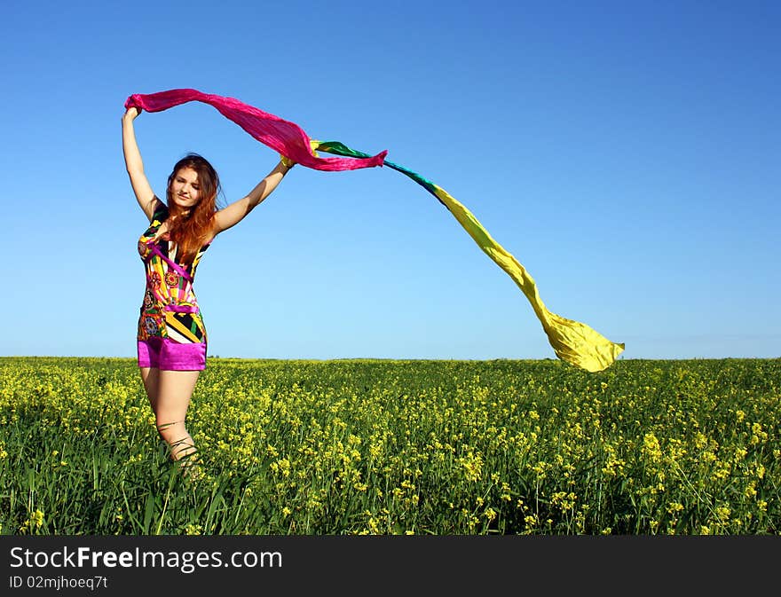 Young beautiful woman on field in summer