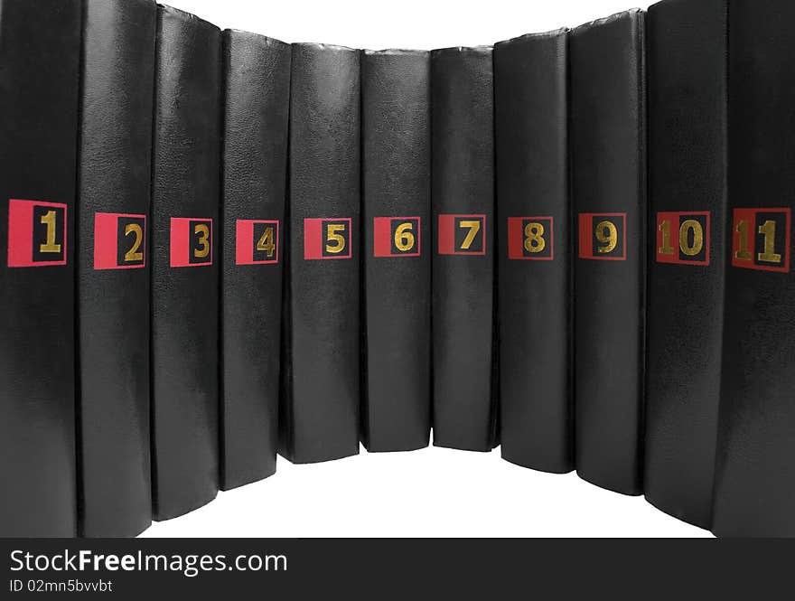 11 black books with the same golden colored numbers isolated on white background. 11 black books with the same golden colored numbers isolated on white background