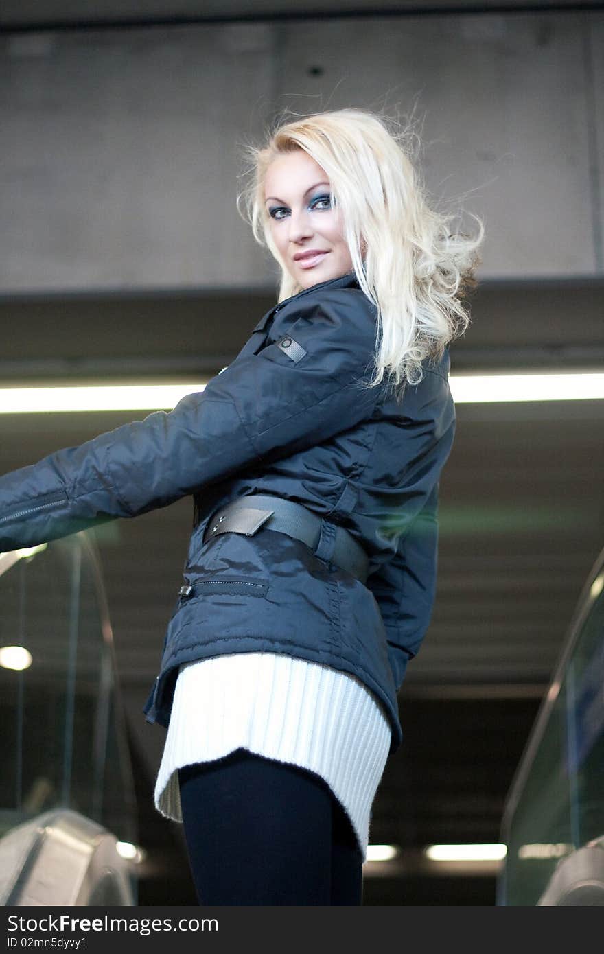 Young blonde on an escalator