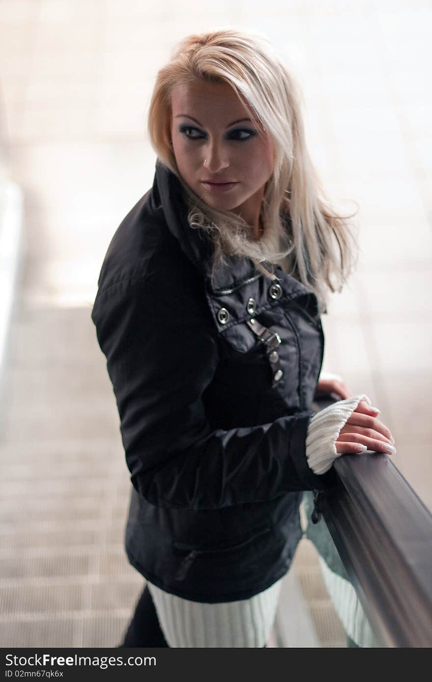 Young blonde on an escalator