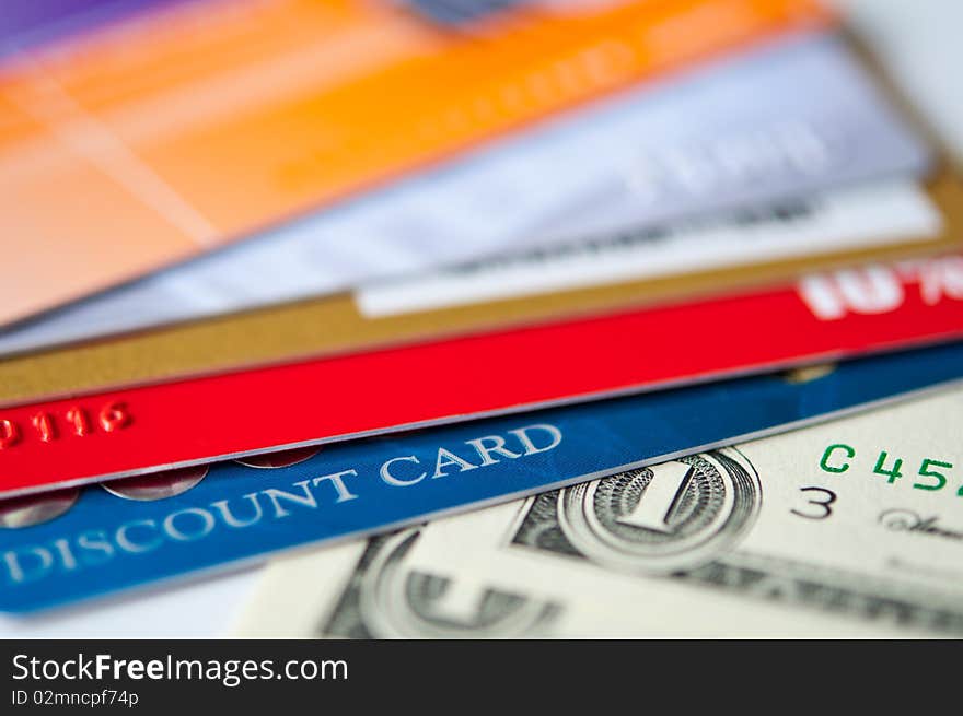 Bright plastic discount cards and usd money closeup. selective focus. Bright plastic discount cards and usd money closeup. selective focus.