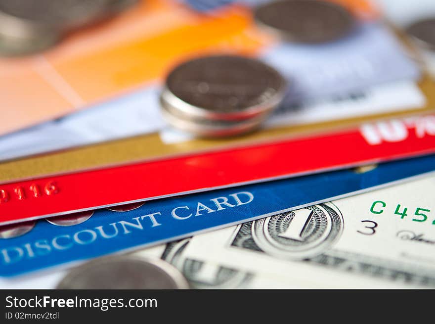 Bright plastic discount cards and usd money closeup. selective focus. Bright plastic discount cards and usd money closeup. selective focus.