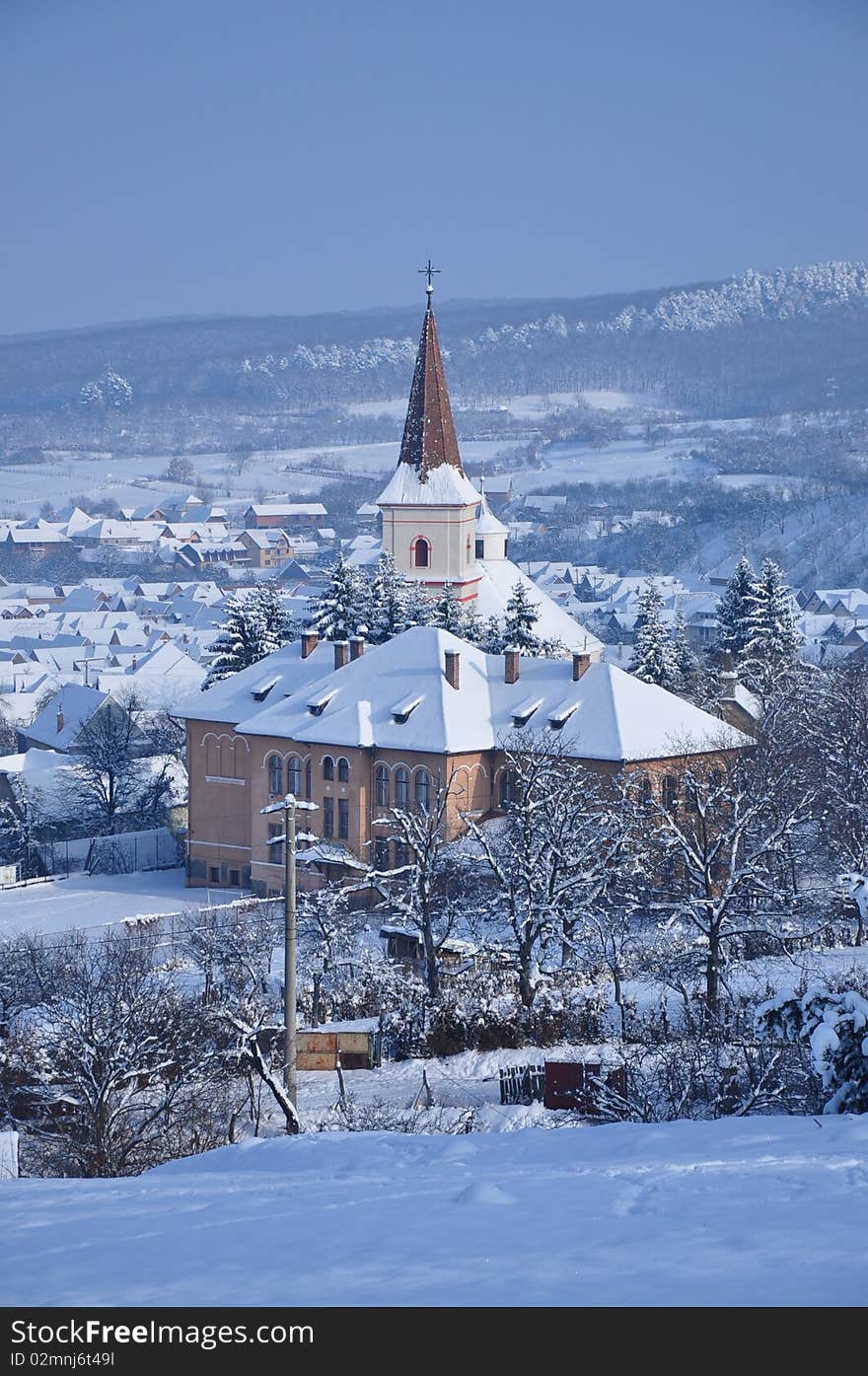 View about a village church dressed in snow. View about a village church dressed in snow