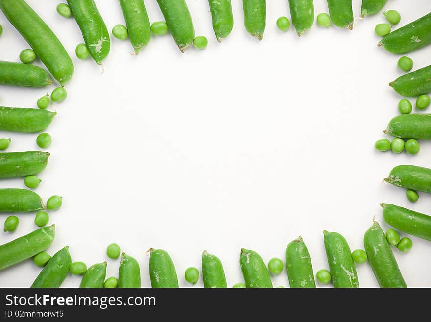 Frame of green peas on white background