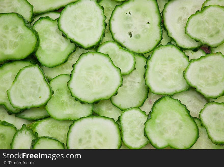 Background of peaces of green cucumber