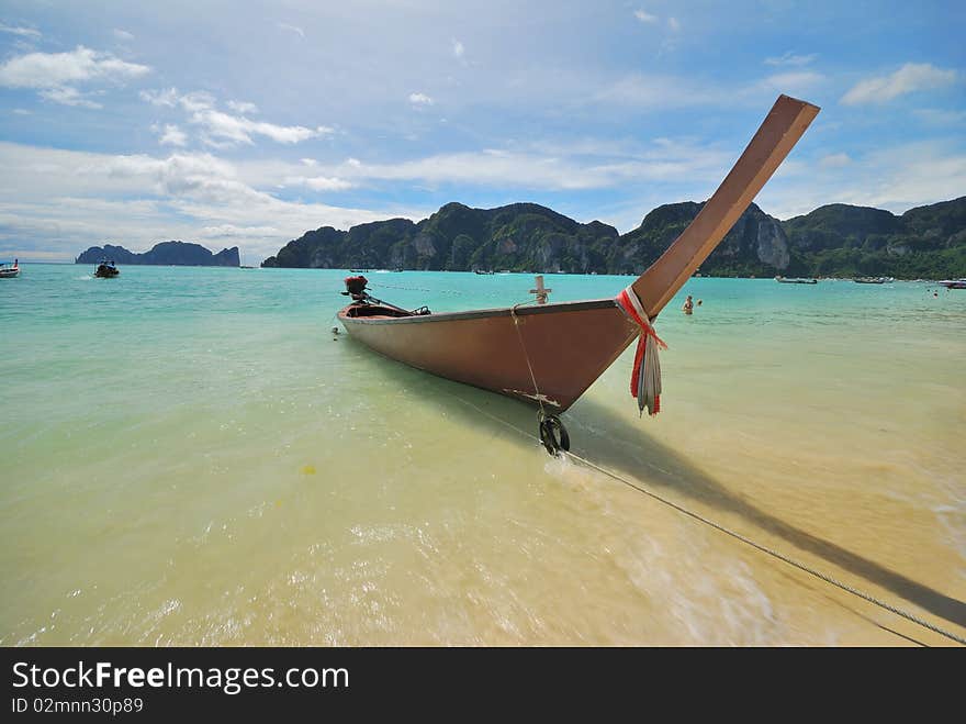 Thai Boat parking on the beach in the day. Thai Boat parking on the beach in the day