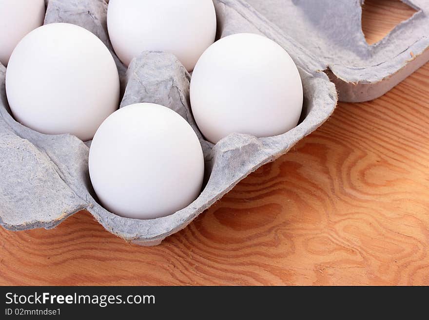 Eggs of white colour are combined in a special tray for transportation and sale.