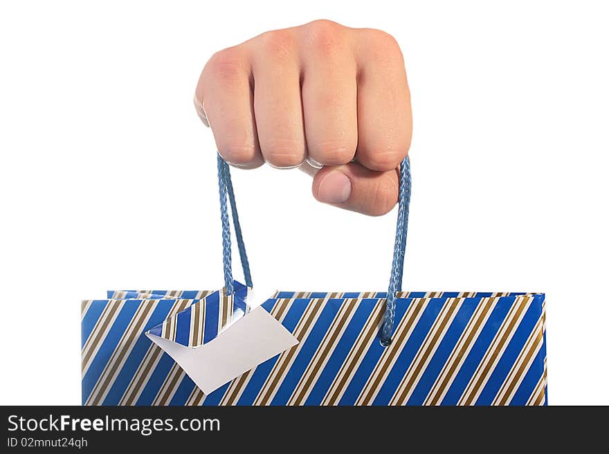 The man's hand holds a cardboard package for gifts. The man's hand holds a cardboard package for gifts.