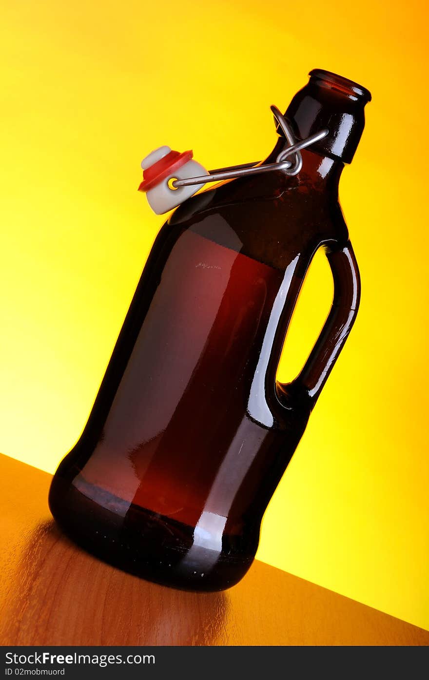 Old beer bottle on yellow background