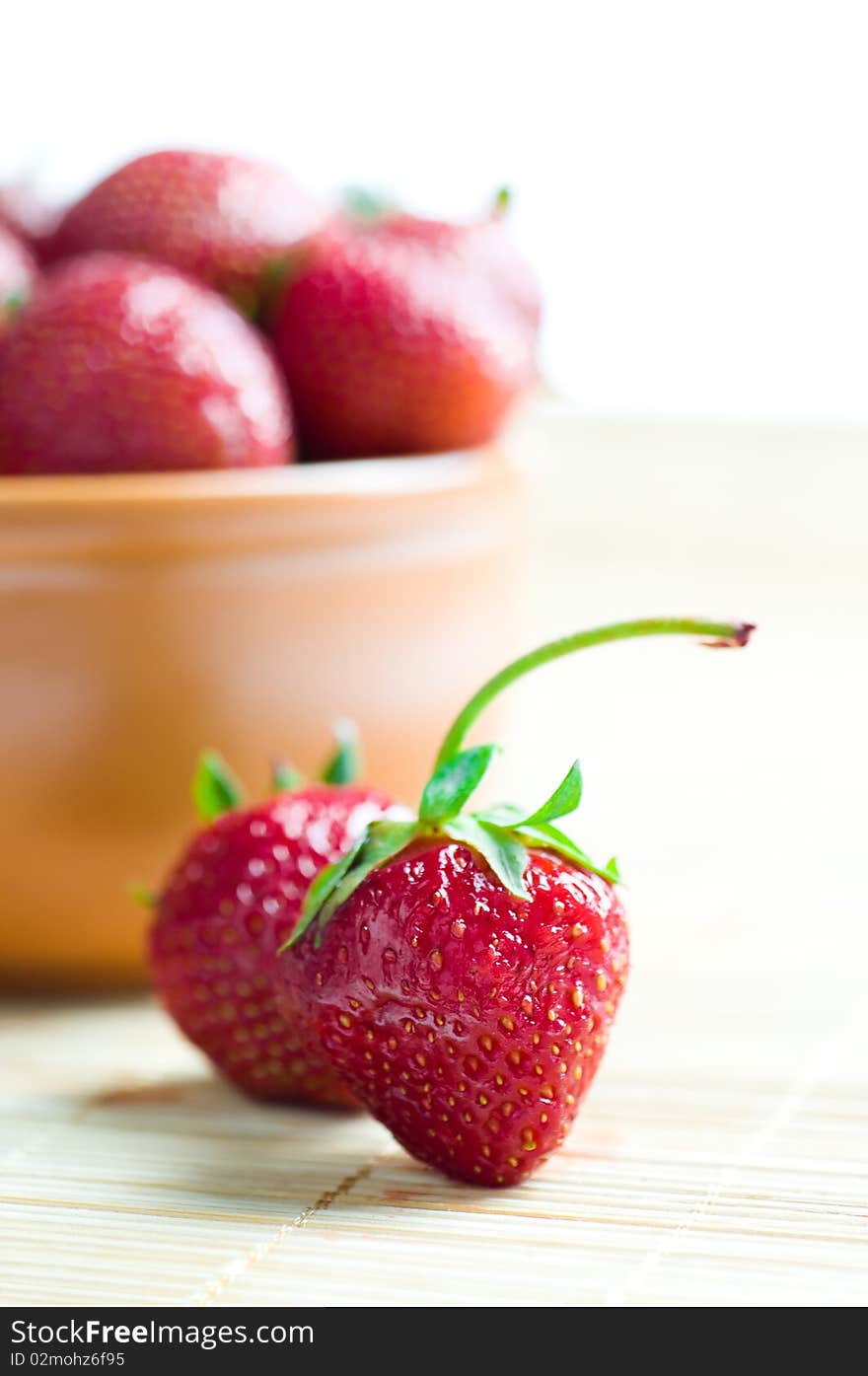 Ripe red strawberries on bamboo background. Ripe red strawberries on bamboo background