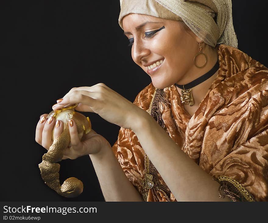 Smiling woman with a gold orange. Smiling woman with a gold orange