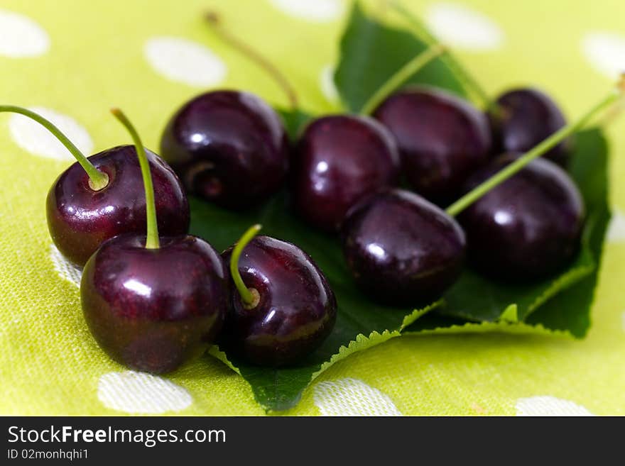 Cherries On Cherry Leaf Background