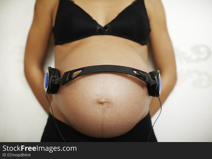 Pregnant woman with headphones