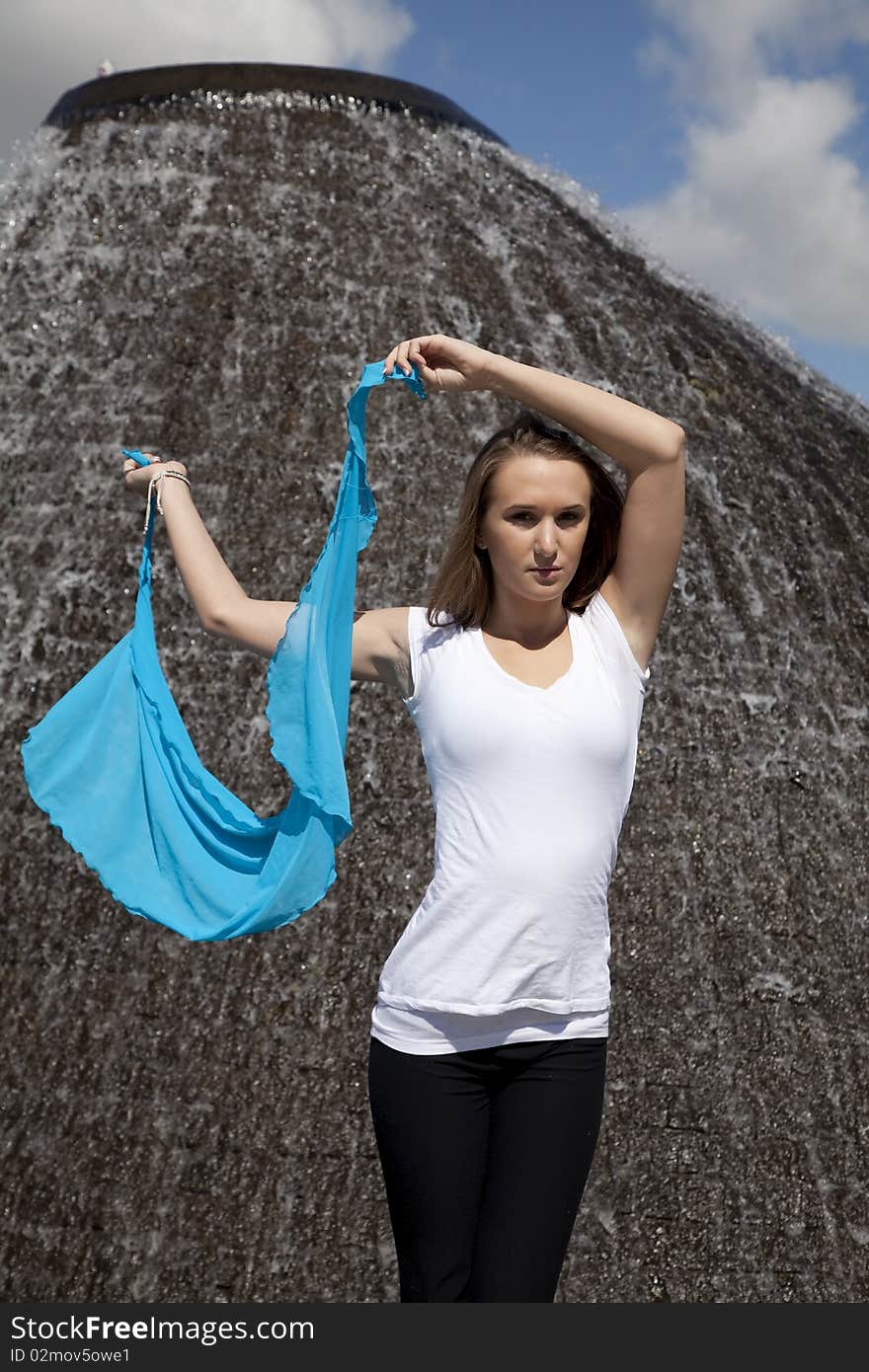 A woman holding her sarong next to her head with a serious expression on  her face. A woman holding her sarong next to her head with a serious expression on  her face.