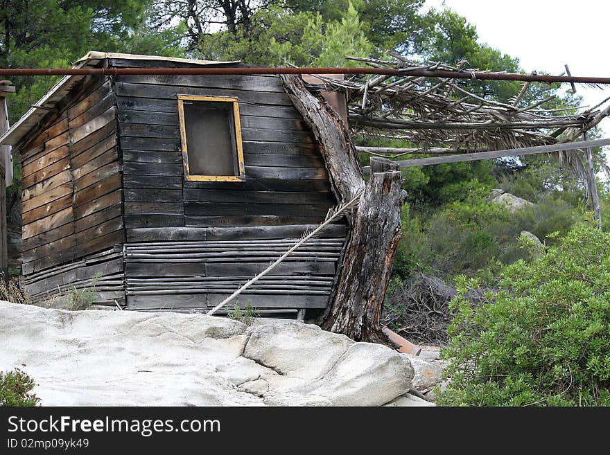 Old ruined wooden hut in a vacations place in Halkidiki in Greece