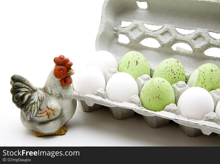 Eggs in the egg cardboard with ceramics chicken. Eggs in the egg cardboard with ceramics chicken