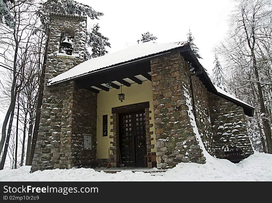 Stone church in the snow, catholic church,. Stone church in the snow, catholic church,