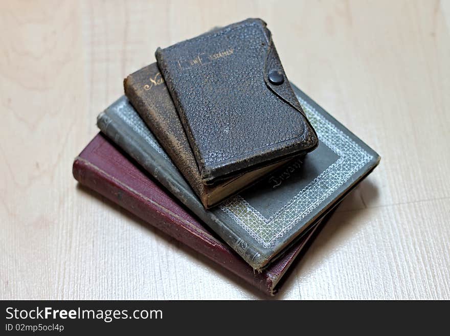 Stack of dusty worn books on poetry and and a bible