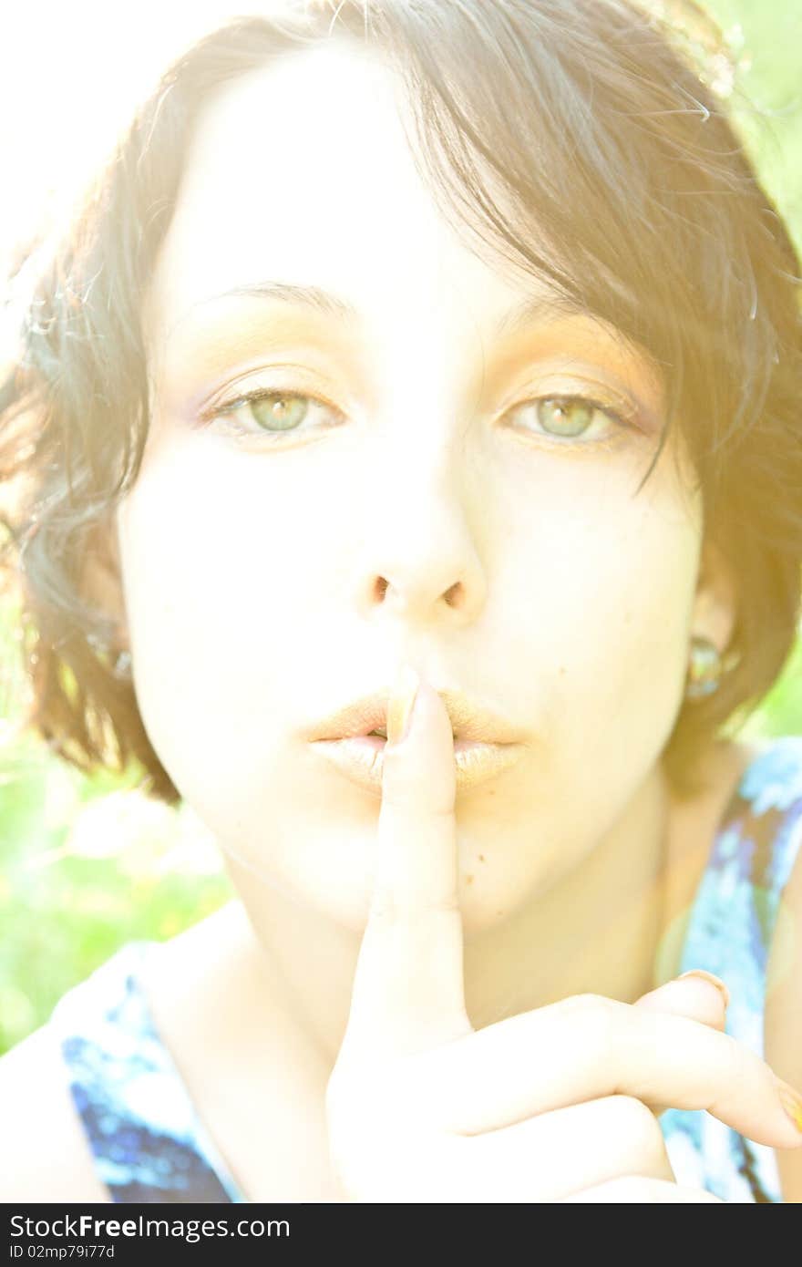 Young woman with green eyes asking for silence. Young woman with green eyes asking for silence