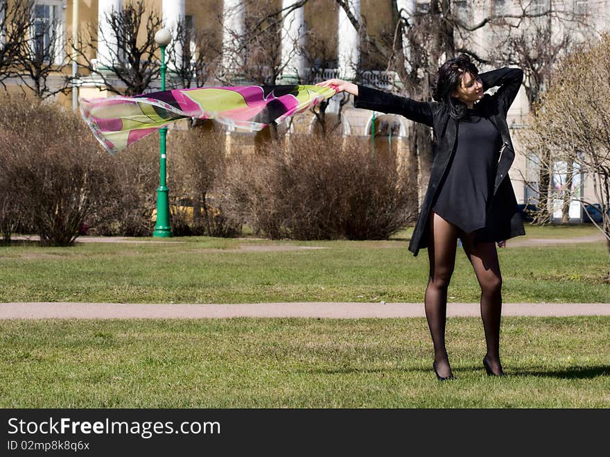 Woman with a waving handkerchief in a spring park